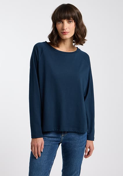 Woman in navy relaxed long sleeve top